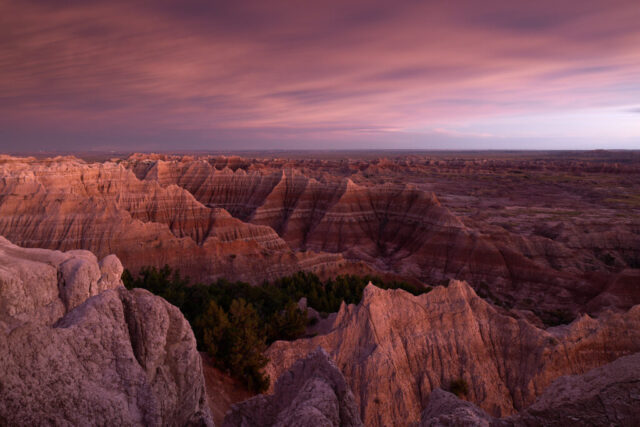 Long exposure image of Badlands National Park in South Dakota after sunset, showing intense red coloration in the landscape